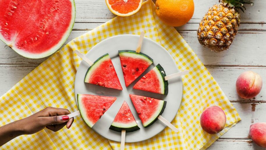 Watermelon slices hanging on stick